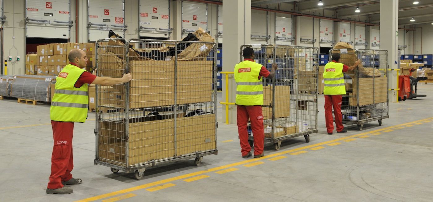 Operarios de Norbert Dentressangle manipulando piezas de automóviles